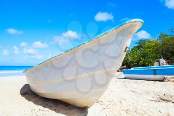 White pleasure boat lays on sand of Macao Beach, coastal landscape. Dominican Republic, Hispaniola Island