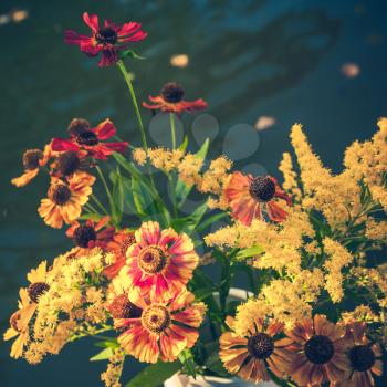 Bouquet of bright colorful summer flowers, square vintage toned photo, old instagram style filter