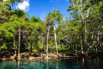 Still blue lake in tropical forest, natural landscape of Dominican Republic