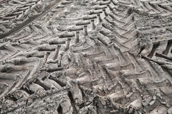 Tractor tire tracks pattern on wet gray ground, abstract transportation background photo