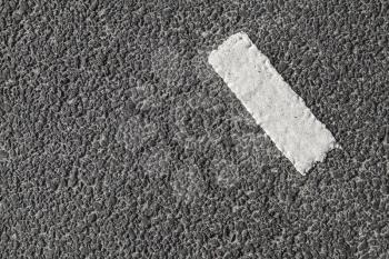 White stripe on dark gray tarmac, highway road marking. Abstract transportation background texture