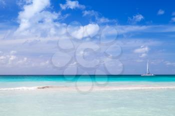 Tropical beach background, white sand, azure water under cloudy blue sky. Caribbean Sea coast, Dominican republic, Saona island