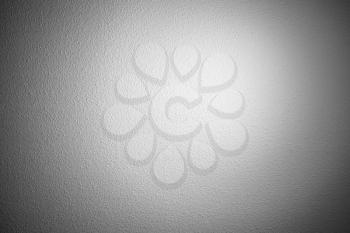 White wall with decorative plastering relief pattern and spotlight, background photo texture