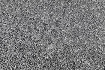 Tarmac road pavement consisting of crushed rock mixed with tar. Background photo texture
