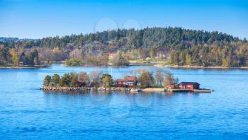 Swedish rural landscape, small island with red wooden houses