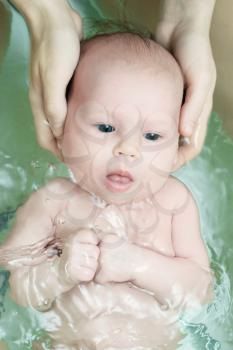 Newborn baby swim with mother care