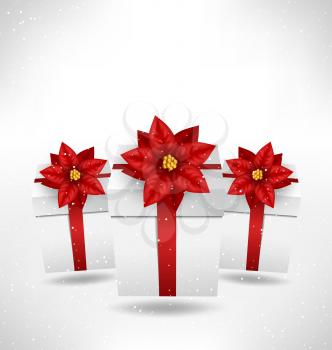 Christmas gift boxes with flower of poinsettia like bows and shadow in snowfall on grayscale background