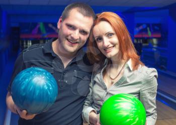 Happy couple in a bowling alley having fun
