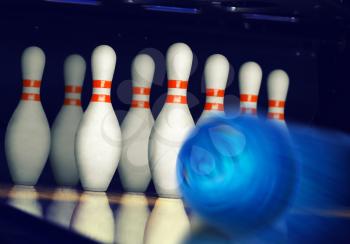 Motion blurred bowling ball on alley