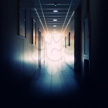 Office building corridor with light at the end