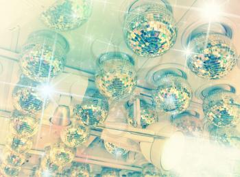 Many disco balls on ceiling in a nightclub