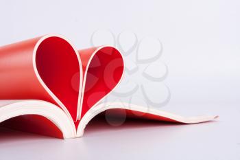Red book pages folded into a heart shape