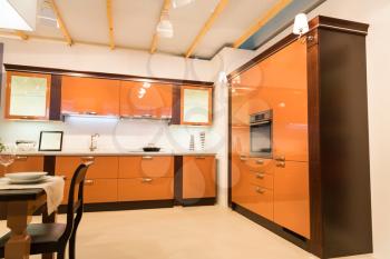 Modern spacious orange kitchen interior