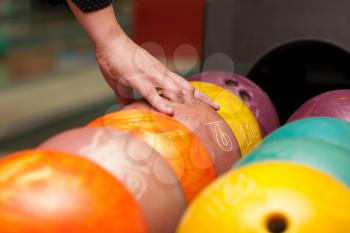 Close-up of bowling player hand taking ball
