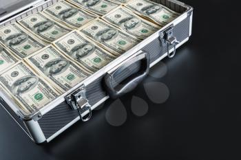 Case full of dollar isolated on gray background