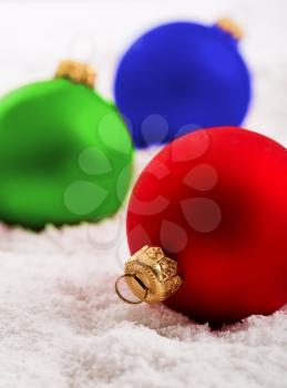Colorful christmas baubles on snow