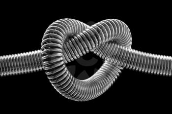Close-up of knotted metal spring. In B/W