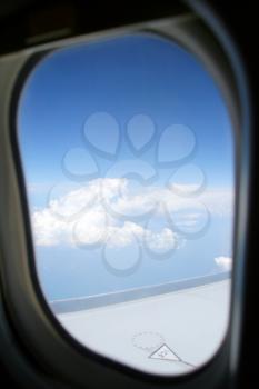 View of airplane wing from porthole