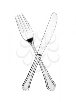 Crossed fork and knife isolated on white