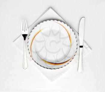 Dinner plate, knife and fork on the table