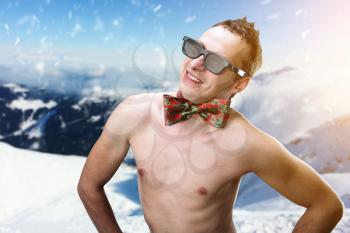 Hot summer naked man in winter mountains