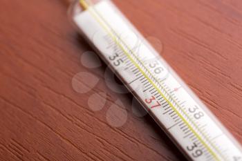 Macro of thermometer on a wooden table