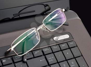 Businessman's glasses on laptop computer