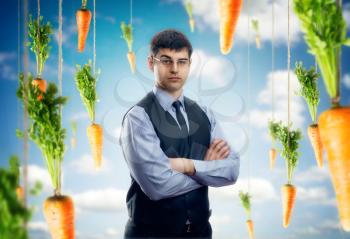 Businessman against blue sky with red carrots  around