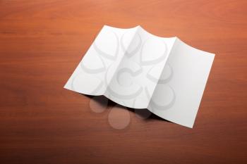 White paper sheet on a wooden table