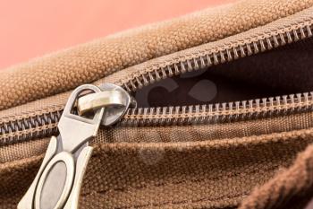 A closeup of  brown bag with open zipper