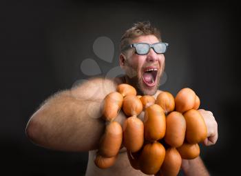 Mad man in glasses with sausages round his hand crying