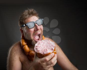 Hungry fat man with sausages round his neck eats a big wurst over grey