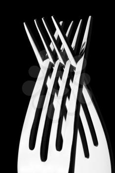 Two crossed silver forks. In B/W