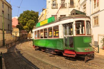 Old tram on narrow european street in sunny days