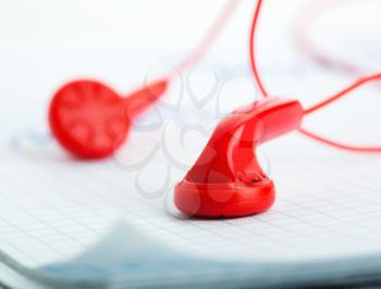 Red headphones on notebook angle view