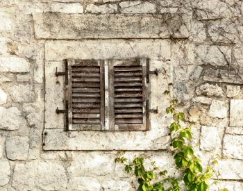Old stone wall with window
