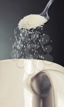 Sugar being poured into a cup