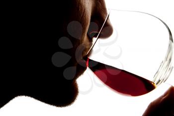 Silhouette of man tasting alcohol. Isolated on white
