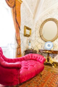 Luxurious room interior with vintage sofa, table and mirror