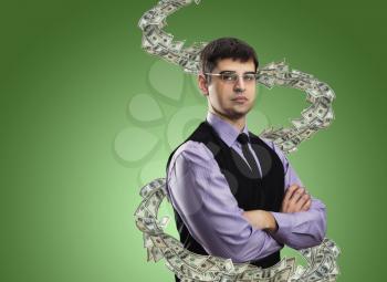 Studio portrait of businessman with money vortex