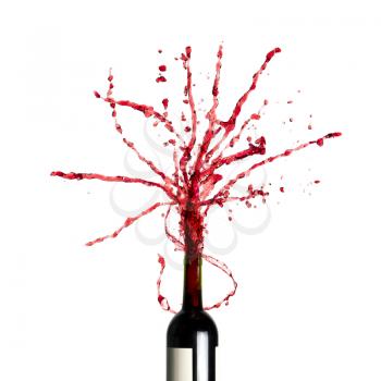 Bottle with splashing red wine