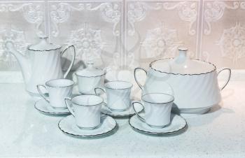 White set of cups for tea with a teapot