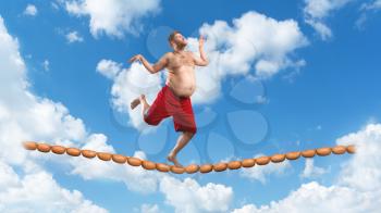 Fat happy man running on the sausage rope in the sky