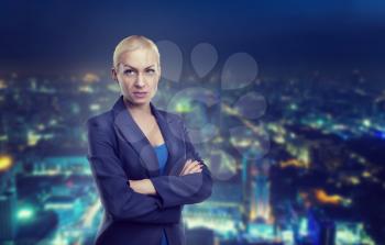 Confident businesswoman against night city background
