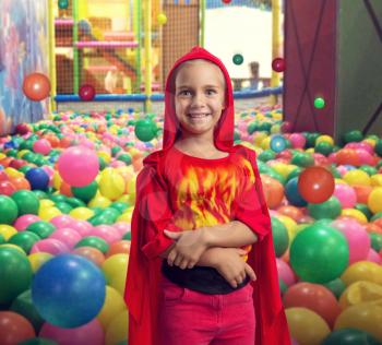 Little girl in masquerade costume in the playing room