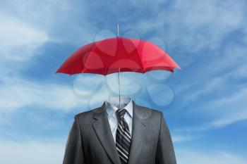 Businessman without head under umbrella over the sky