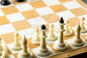 Black chess figures on the board ready to fight