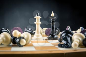 Chess kings surrouded by lying figures