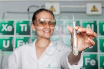 Smiling woman with test tube in the lab