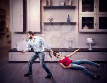 Angry man pulling woman by the hair at home